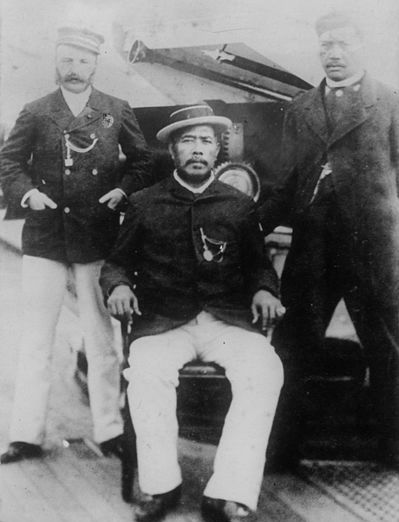 Prince Robert Hoapili Baker I at right (pictured here at rank of Major, then later became Colonel), cousin and royal aide-de-camp of King David Kalākaua. Colonel G. Macfarlane, at left. King David Kalākaua, at center, aboard the U.S.S. Charleston