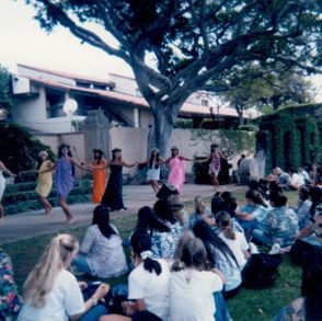 Hula dance of the May Day Court representing each of the nine Hawaiian Islands for La Pietra's May Day Celebration. Ke Ali'i Idony Punahele Hoapili is pictured dancing in front wearing the violet of the island of Kaua'i, 